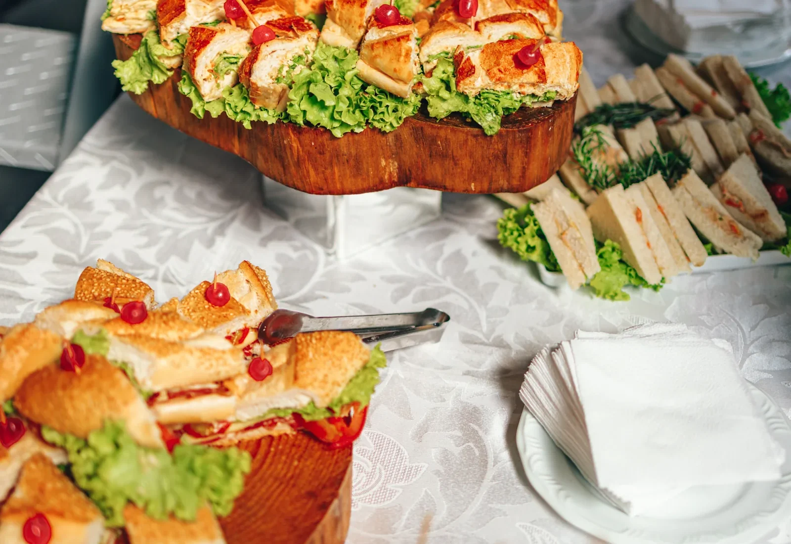A generous display of small sandwiches at a gathering