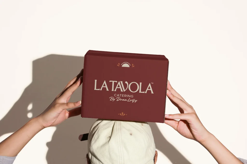 Hands holding a La Tavola catering box